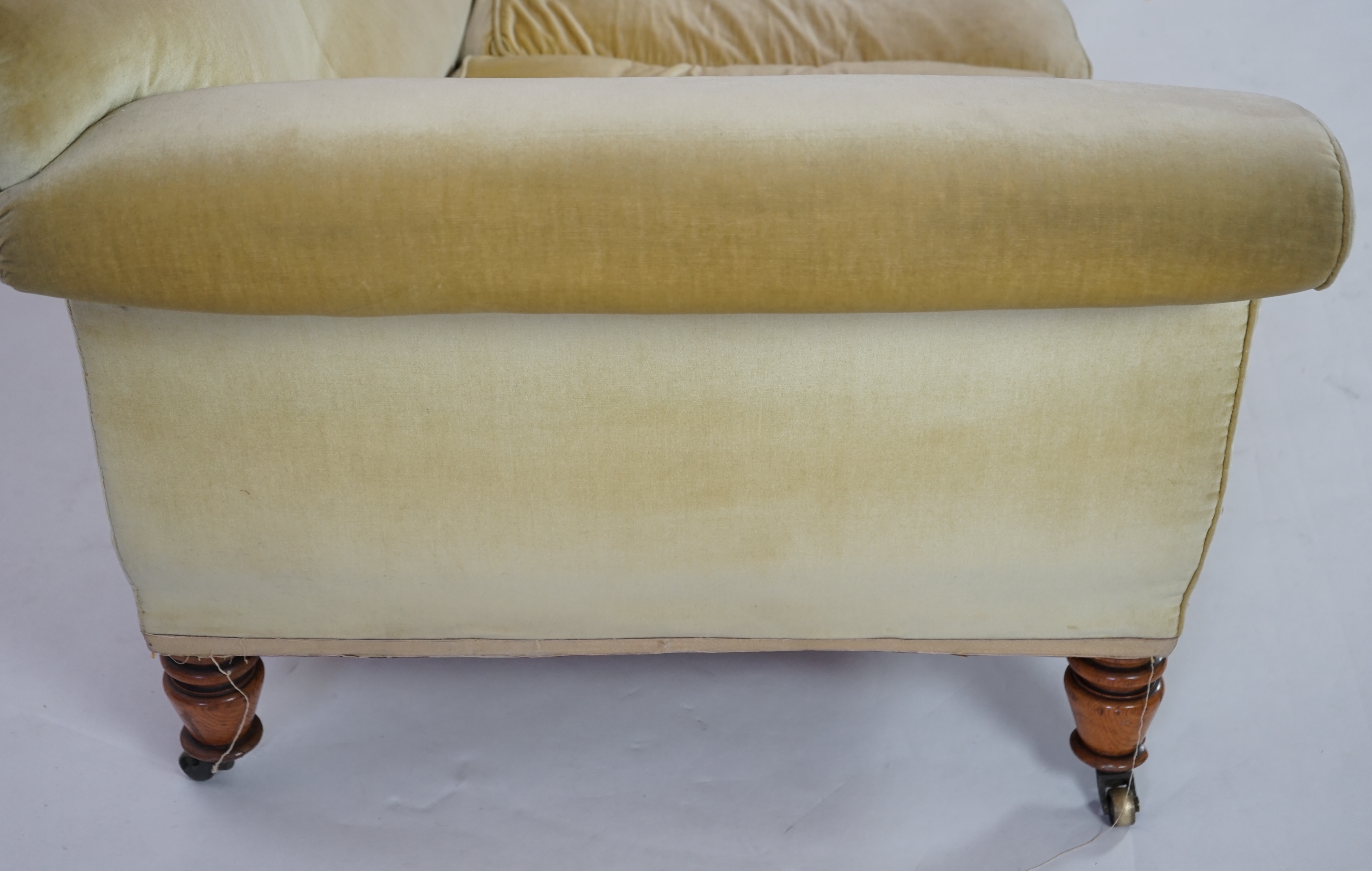 A large Victorian sofa, in the manner of Howard & Sons, probably Swietenia mahagoni with a Fagus sylvatica frame